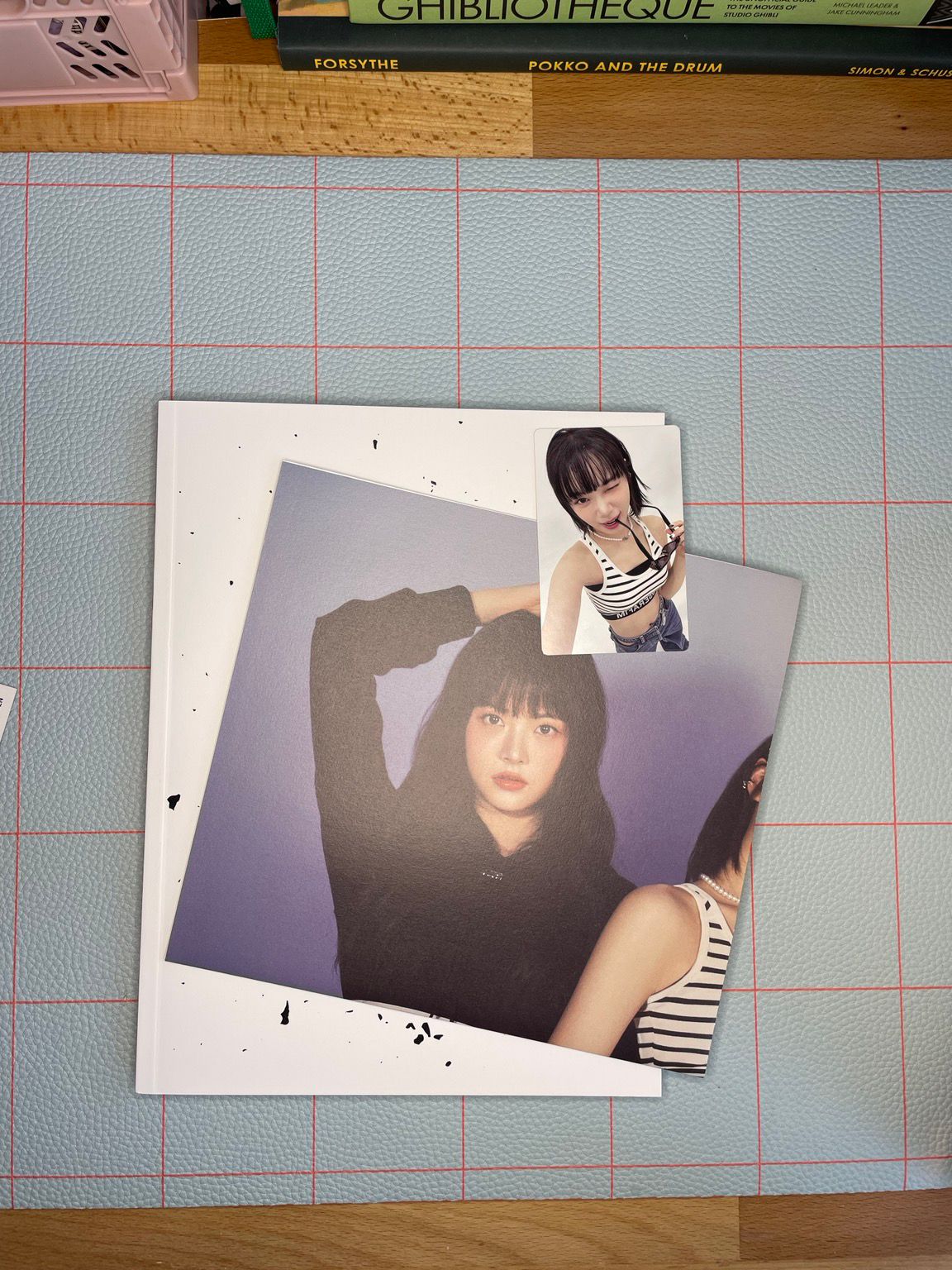 Showing a poster and photo card from ale Sserafim’s album